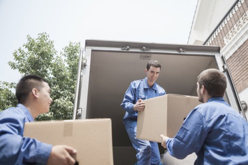 Loading furniture and boxes into a removals van for a Noak Hill customer