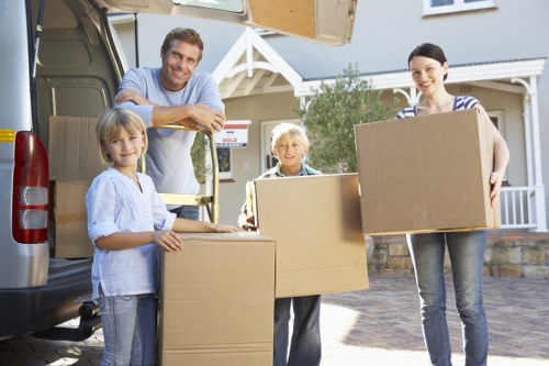 Removal team transporting household items for a Noak Hill move