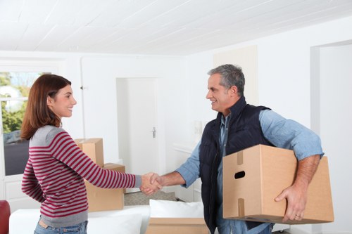 Professional movers handling furniture in a Noak Hill residential street